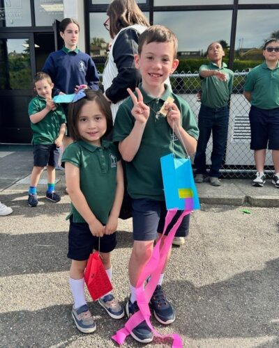 Tala was full of joy flying her kite alongside her friend Robbie. They are great school friends who also share time in the Saint Patrick Catholic Church Catechesis of the Good Shepherd atrium. Robbie enthusiastically passed on his new discovery: longer tails help kites fly better!

Mrs. Emily Keller, the Shamrock alum and artist in residence, helped Shamrock kite pilots understand the importance of the kite tail—not only for flight, but also as a space for creative expression. Each child added their artistic flair, making every kite as unique and vibrant as the one who flew it.

A day of friendship, learning, and joyful moments—grounded in wonder and lifted by the wind.